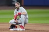 Philadelphia Phillies first baseman Bryce Harper (3) takes a break during a pitching change by the New York Mets during the sixth inning of Game 4 of the National League baseball playoff series, Wednesday, Oct. 9, 2024, in New York. (AP Photo/Frank Franklin II)