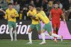 Australia's Nishan Velupillay, second left, is congratulated by teammate Riley McGree after scoring his team's third goal during the World Cup 2026 Group C qualifying soccer match between Australia and China at Adelaide Oval, Adelaide, Australia, Thursday Oct. 10, 2024. (AP Photo/James Elsby)