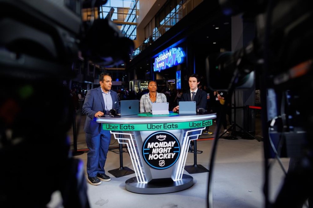 From left, Adnan Virk, Blake Bolden, and Thomas Hickey record their analysis of the night during the Toronto Maple Leafs pre-season hockey game against the Detroit Red Wings as Amazon rehearses their production of Monday Night Hockey, at Scotiabank Arena in Toronto, Saturday, October 5, 2024. THE CANADIAN PRESS/Cole Burston