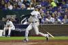 New York Yankees' Juan Soto follows through on a sacrifice fly to score Anthony Volpe during the fifth inning in Game 3 of an American League Division baseball playoff series against the Kansas City Royals Wednesday, Oct. 9, 2024, in Kansas City, Mo. (AP Photo/Colin Braley)