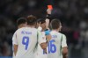 Italy's Lorenzo Pellegrini, center, receives a red card during the UEFA Nations League soccer match between Italy and Belgium at the Stadio Olimpico in Rome, Italy, on Thursday, Oct. 10, 2024. (AP Photo/Alessandra Tarantino)