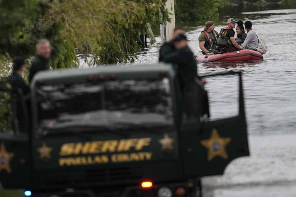People are rescued from an apartment complex after heavy flooding in the aftermath of Hurricane Milton, Thursday, Oct. 10, 2024, in Clearwater, Fla. (AP Photo/Mike Stewart)