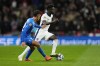 England's Bukayo Saka, right, and Greece's Dimitris Giannoulis challenge for the ball during the UEFA Nations League Group F soccer match between England and Greece at Wembley Stadium in London, Thursday, Oct. 10, 2024. (AP Photo/Kirsty Wigglesworth)