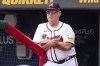 Atlanta Braves manager Brian Snitker watches from the dugout in the third inning of a baseball game against the New York Mets, Monday, Sept. 30, 2024, in Atlanta. (AP Photo/Jason Allen)