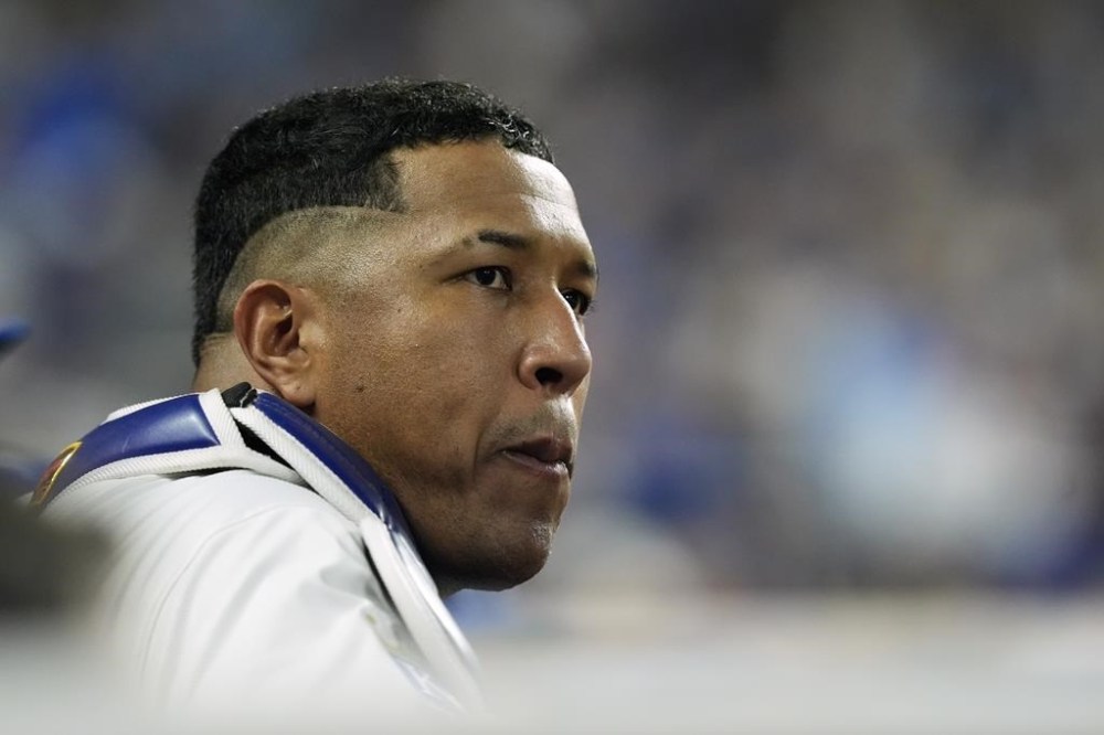 Kansas City Royals' Salvador Perez watches from the dugout during the fifth inning in Game 4 of an American League Division baseball playoff series against the New York Yankees Thursday, Oct. 10, 2024, in Kansas City, Mo. (AP Photo/Charlie Riedel)