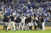 Members of the New York Yankees celebrate after defeating the Kansas City Royals 3-1 in Game 4 of an American League Division baseball playoff series and move on to the ALCS Thursday, Oct. 10, 2024, in Kansas City, Mo. (AP Photo/Reed Hoffmann)