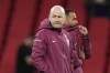 England's head coach Lee Carsley, left, walks on the pitch before the UEFA Nations League Group F soccer match between England and Greece at Wembley Stadium in London, Thursday, Oct. 10, 2024. (AP Photo/Kirsty Wigglesworth)