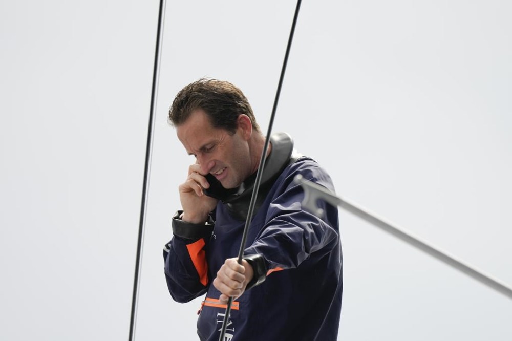Ineos Britannia skipper Ben Ainslie talks on the phone before the Louis Vuitton 37th America's Cup race in Barcelona, Spain, Saturday, Oct. 12, 2024. (AP Photo/Bernat Armangue)