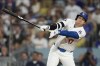 Los Angeles Dodgers' Shohei Ohtani strikes out during the sixth inning in Game 5 of a baseball NL Division Series against the San Diego Padres, Friday, Oct. 11, 2024, in Los Angeles. (AP Photo/Ashley Landis)