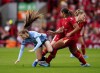 Manchester City's Jess Park, left, battles for the ball with Liverpool's Marie Hobinger, rear, and Olivia Smith, right, during the Women's Super League match between Liverpool and Manchester City at Anfield, Liverpool, England, Sunday, Oct. 13, 2024. THE CANADIAN PRESS/PA via AP-Mike Egerton