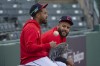 Cleveland Guardians bullpen coach Eric Rodriguez, left, chats with Pedro Avila during a baseball workout in Cleveland, Friday, Oct. 11, 2024, in preparation for Saturday's Game 5 of the American League Division Series against the Detroit Tigers.(AP Photo/Phil Long)