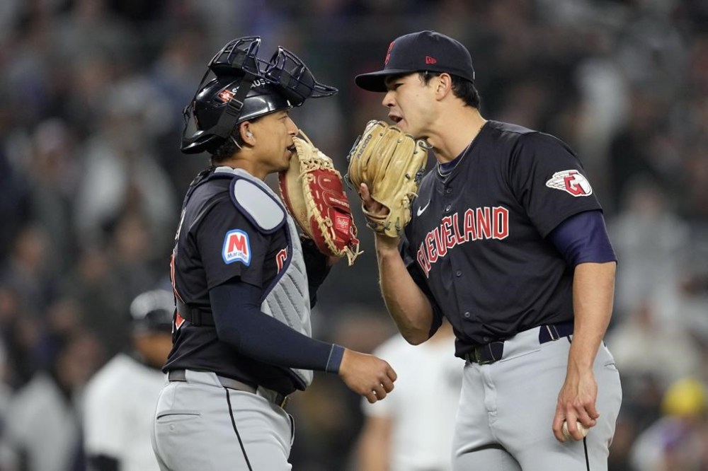 Cleveland Guardians pitcher Joey Cantillo, right, talks with catcher Bo Naylor during the third inning in Game 1 of the baseball AL Championship Series against the New York Yankees Monday, Oct. 14, 2024, in New York. (AP Photo/Godofredo Vásquez)