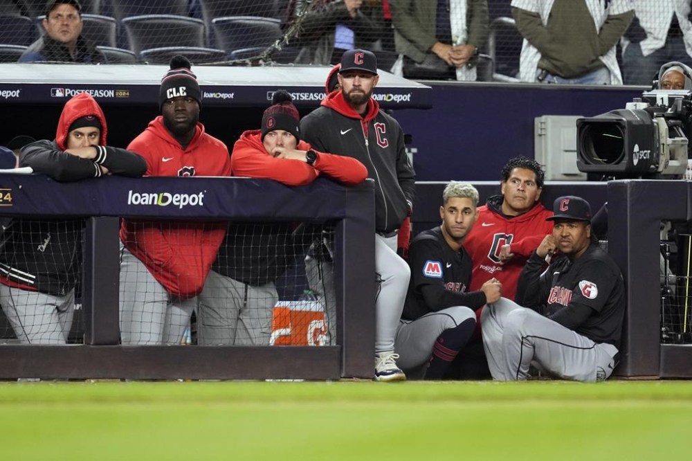 Cleveland Guardians players watch from the dugout during the ninth inning in Game 1 of the baseball AL Championship Series against the New York Yankees Monday, Oct. 14, 2024, in New York. (AP Photo/Godofredo Vásquez)