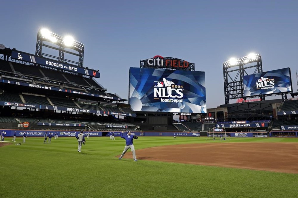 Los Angeles Dodgers players throw during a workout Tuesday, Oct. 15, 2024, in New York ahead of Game 3 of the baseball NL Championship Series against the New York Mets. (AP Photo/Adam Hunger)