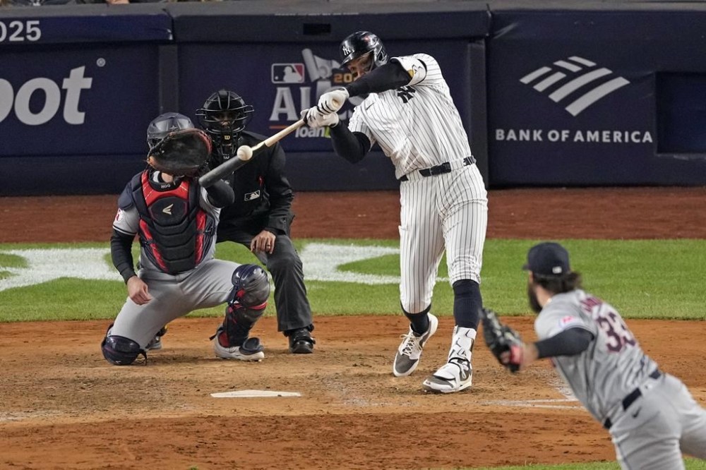 New York Yankees' Aaron Judge, center, hits a two-run home run off Cleveland Guardians relief pitcher Hunter Gaddis (33) during the seventh inning in Game 2 of the baseball AL Championship Series Tuesday, Oct. 15, 2024, in New York. (AP Photo/Seth Wenig)
