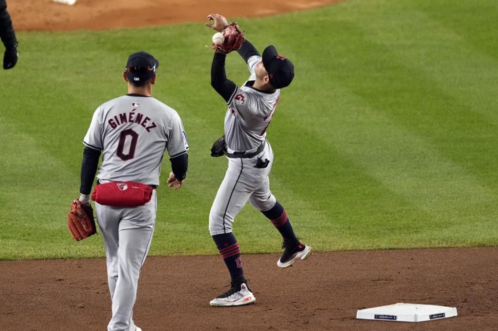 Cleveland Guardians shortstop Brayan Rocchio misses catching a pop fly by New York Yankees' Aaron Judge during the first inning in Game 2 of the baseball AL Championship Series Tuesday, Oct. 15, 2024, in New York. Rocchio was charged with an error. (AP Photo/Seth Wenig)