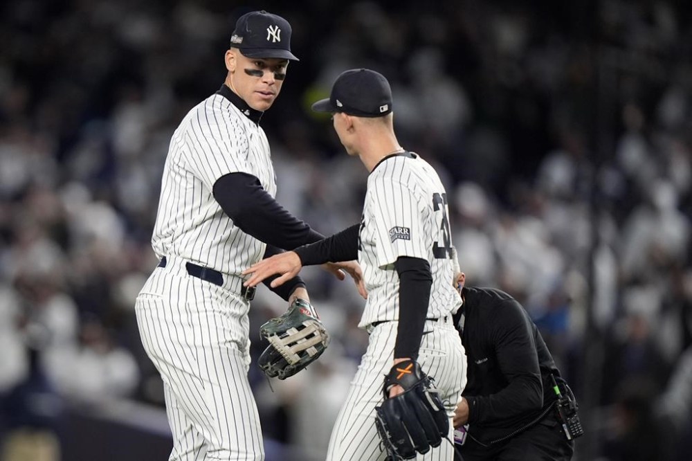 New York Yankees' Aaron Judge, left, celebrates with Luke Weaver after Game 2 of the baseball AL Championship Series against the Cleveland Guardians Tuesday, Oct. 15, 2024, in New York. The Yankees won 6-3. (AP Photo/Frank Franklin II)