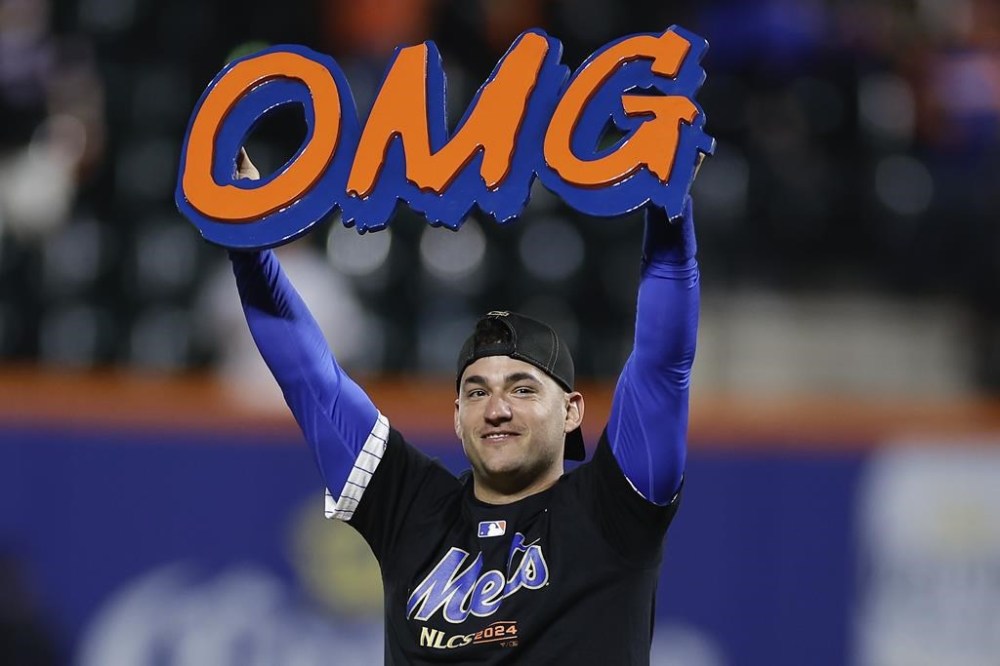 FILE - New York Mets second baseman Jose Iglesias celebrates on the field after the Mets beat the Philadelphia Phillies in Game 4 of the National League baseball playoff series, Oct. 9, 2024, in New York. (AP Photo/Adam Hunger, File)
