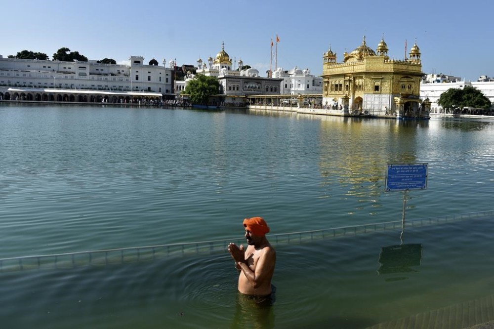 A Sikh devotee prays at the Golden Temple, Sikhism's holiest shrine, in Amritsar, India, Sept. 20, 2023. As tensions escalate between India and Canada amid allegations of violent crimes, some in the Indian diaspora say they’re concerned about how the situation could affect Canadians with plans to see loved ones in India. (AP Photo/Prabhjot Gill)
