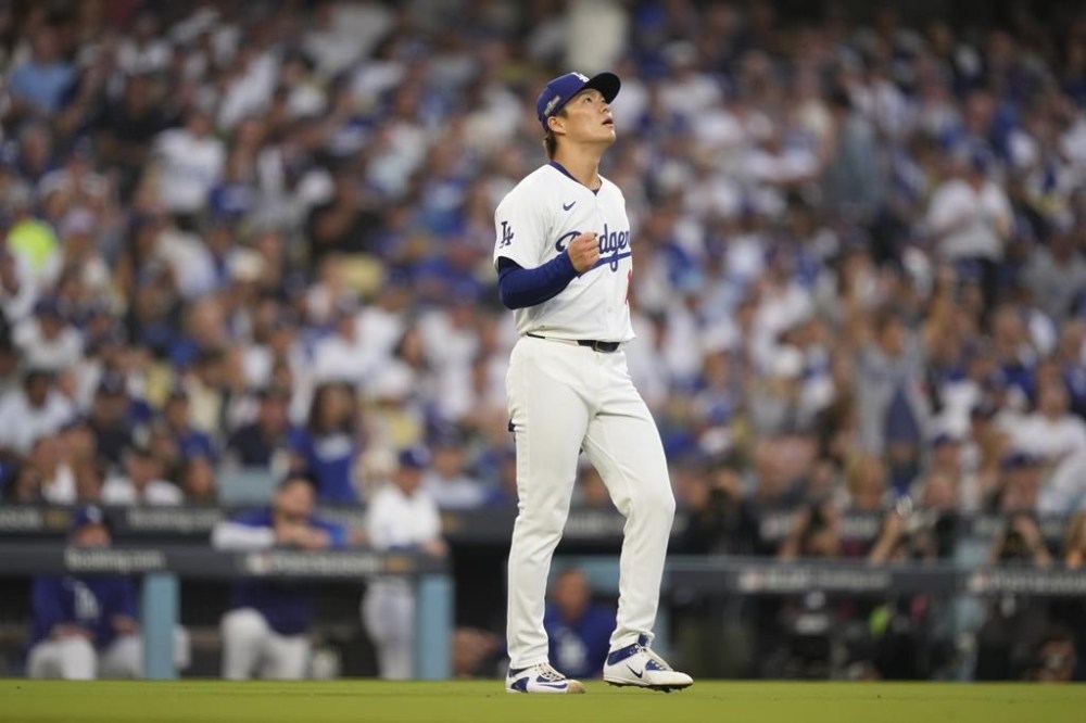 Los Angeles Dodgers starting pitcher Yoshinobu Yamamoto reacts as San Diego Padres' Jackson Merrill flies out during the fourth inning in Game 5 of a baseball NL Division Series Friday, Oct. 11, 2024, in Los Angeles. (AP Photo/Mark J. Terrill)