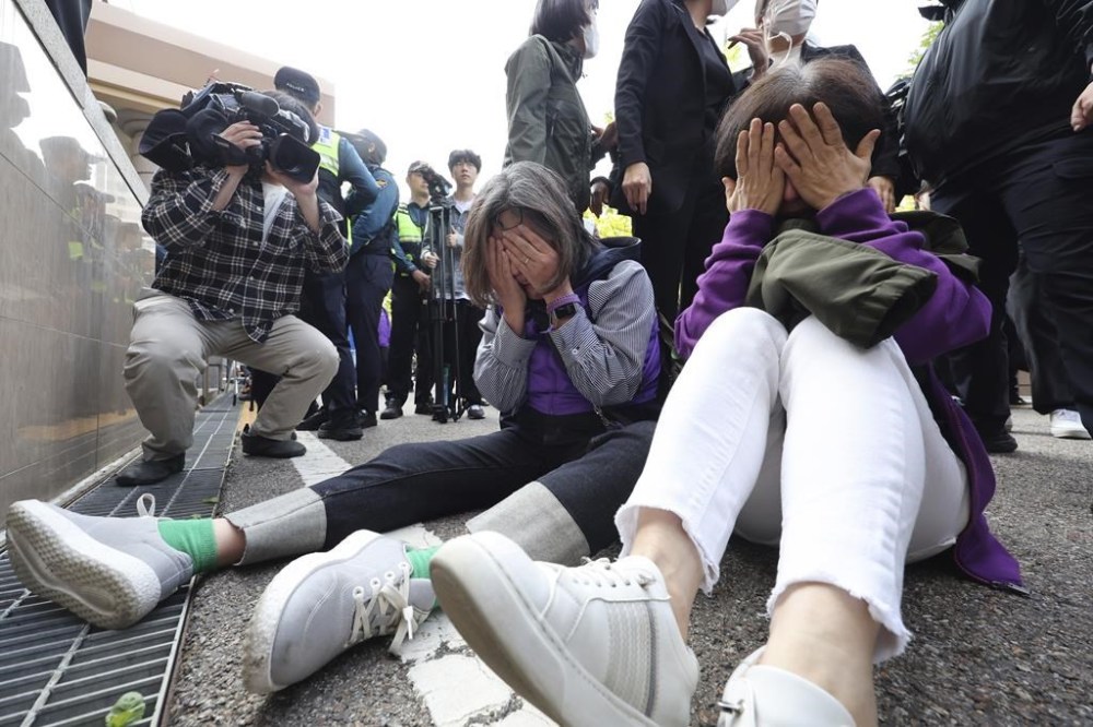 Bereaved family members of the victims of the Halloween crush in 2022 react at the Seoul Western District Court in Seoul, South Korea, Thursday, Oct. 17, 2024. (Lim Hwa-young/Yonhap via AP)