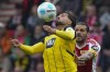 Dortmund's Emre Can receives the ball in front of Union's Christopher Trimmel during the Bundesliga soccer match between Union Berlin and Borussia Dortmund in Berlin, Germany, on Saturday, Oct. 5, 2024.(AP Photo/Ebrahim Noroozi)