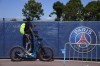 FILE - A soccer fan tries to watch the PSG soccer team training at the Paris Saint-Germain training camp in Saint-Germain-en-Laye, west of Paris, Friday, Aug. 13, 2021. (AP Photo/Francois Mori, File)