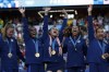 FILE - The United States team players stand with their gold medals during the medal ceremony after the women's soccer gold medal match between Brazil and the United States at the Parc des Princes during the 2024 Summer Olympics, Aug. 10, 2024, in Paris, France. (AP Photo/Aurelien Morissard, File)