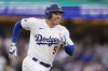 Los Angeles Dodgers' Freddie Freeman runs to first base as he singles during the first inning in Game 5 of a baseball NL Division Series against the San Diego Padres, Friday, Oct. 11, 2024, in Los Angeles. (AP Photo/Mark J. Terrill)