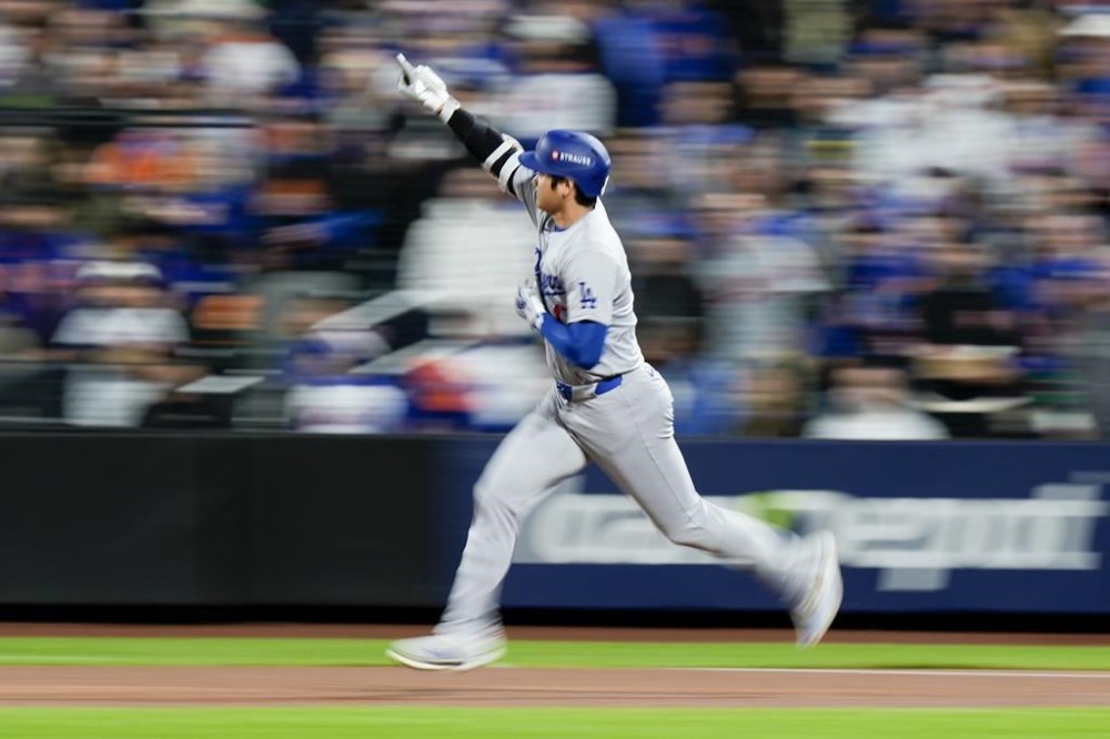Los Angeles Dodgers' Shohei Ohtani celebrates after a home run against the New York Mets during the first inning in Game 4 of a baseball NL Championship Series, Thursday, Oct. 17, 2024, in New York. (AP Photo/Frank Franklin II)