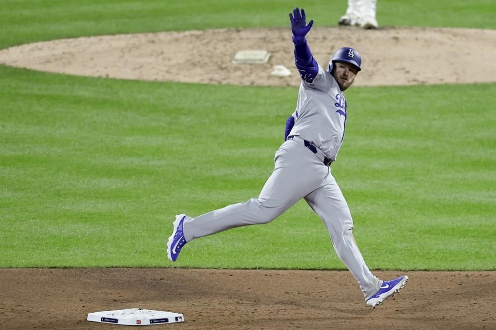 Los Angeles Dodgers' Max Muncy celebrates his home run against the New York Mets during the ninth inning in Game 3 of a baseball NL Championship Series, Wednesday, Oct. 16, 2024, in New York. (AP Photo/Adam Hunger)