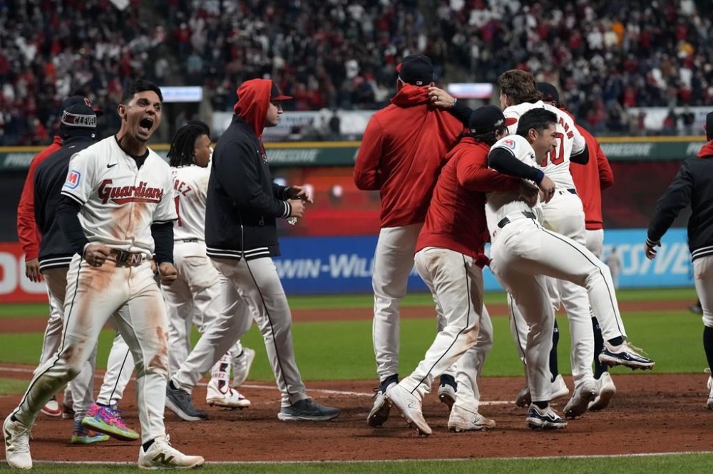 Cleveland Guardians players celebrate after David Fry's game-winning two-run home run against the New York Yankees during the 10th inning in Game 3 of the baseball AL Championship Series Thursday, Oct. 17, 2024, in Cleveland. The Guardians won 7-5. (AP Photo/Godofredo Vásquez )
