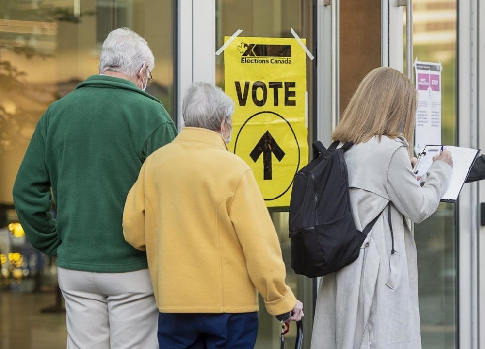 Voters line up at the Halifax Convention Centre as they prepare to vote in the federal election in Halifax on Sept. 20, 2021. Results of the Halifax municipal election will be known tonight as voters head to the polls to choose their next mayor. THE CANADIAN PRESS/Andrew Vaughan