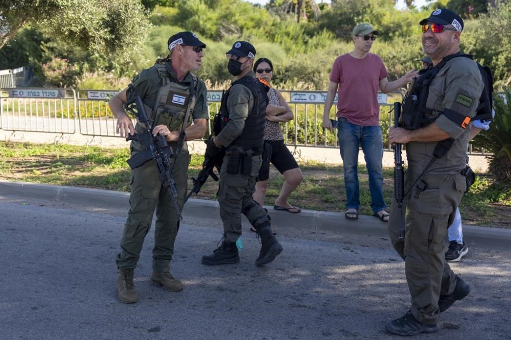 Israeli security forces secure a road near where Israel's government says a drone launched toward Israeli Prime Minister Benjamin Netanyahu's house in Caesarea, Israel Saturday, Oct. 19, 2024. (AP Photo/Ariel Schalit)