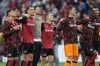 Leverkusen players celebrate after the German Bundesliga soccer match between Bayer Leverkusen and Eintracht Frankfurt at the BayArena in Leverkusen, Germany, Saturday, Oct. 19, 2024. (AP Photo/Martin Meissner)