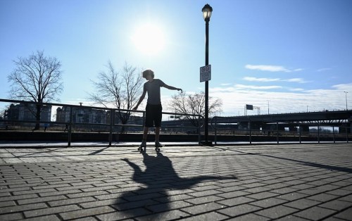 Montreal skateboarders are rallying to protect a Do-It-Yourself skatepark known as Project 45 from what the city has said are plans to redevelop the space but skaters fear are plans to demolish what makes it unique. A person skateboards next to the canal in Sainte-Anne-de-Bellevue, Que., west of Montreal, Sunday, March 3, 2023, on a mild winter day. THE CANADIAN PRESS/Graham Hughes