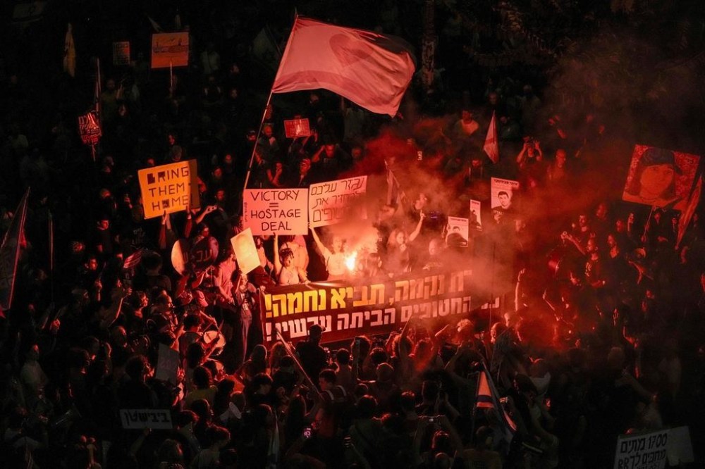 People protest against Prime Minister Benjamin Netanyahu's government and call for the release of hostages held in the Gaza Strip by the Hamas militant group, in Tel Aviv, Israel, Saturday, Oct. 19, 2024. (AP Photo/Mahmoud Illean)