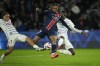 PSG's Bradley Barcola, center, is challenged by Strasbourg's Mamadou Sarr, right, and Diego Moreira during the French League One soccer match between Paris Saint-Germain and Strasbourg at the Parc des Princes in Paris, Saturday, Oct. 19, 2024. (AP Photo/Christophe Ena)