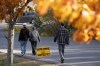 Voters walk past a voting sign after casting their ballot in the New Brunswick provincial election at a polling location in Fredericton, N.B., on Monday, Oct. 21, 2024. THE CANADIAN PRESS/Darren Calabrese