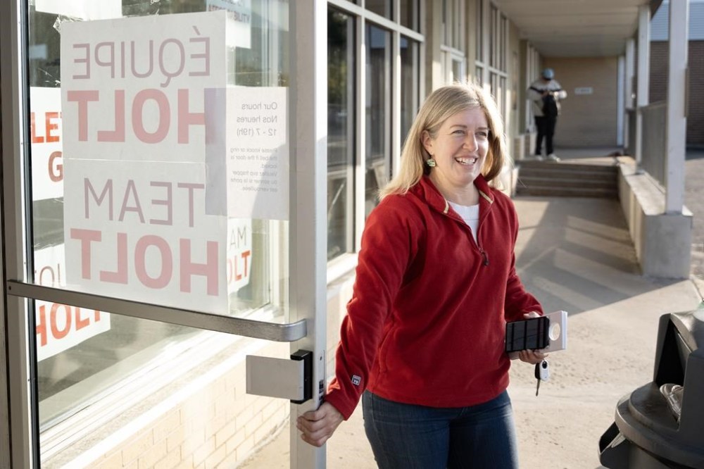 New Brunswick Liberal Party Leader Susan Holt holds the door for volunteers leaving her headquarters to knock on doors in her riding in Fredericton, Saturday, Oct. 19, 2024. THE CANADIAN PRESS/Darren Calabrese