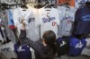 A customer shops around for goods related to Shohei Ohtani of the Los Angeles Dodgers at a sporting goods store, 