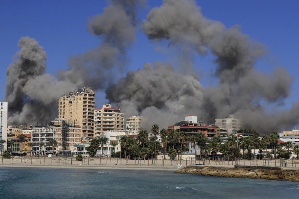 Smoke rises from buildings hit in Israeli airstrikes in Tyre, Lebanon, Wednesday, Oct. 23, 2024. (AP Photo/Mohammad Zaatari)