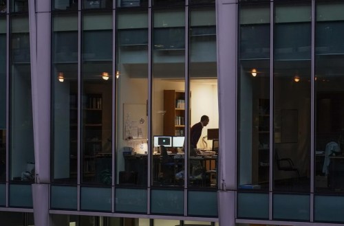 A newly published report based on a large survey of federal public servants suggests working remotely is associated with fewer emissions compared to in-office work. A worker is shown in an office in the financial district in London, Monday, Dec. 13, 2021. THE CANADIAN PRESS/AP/Alberto Pezzali