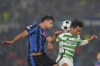 Atalanta's Berat Djimsiti, left, and Celtic's Reo Hatate battle for a head ball during the Champions League soccer match between Atalanta BC and Celtic FC at Gewiss Stadium in Bergamo, Italy, Wednesday Oct. 23, 2024. (Spada/LaPresse via AP)