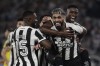 Alexander Barboza of Brazil's Botafogo, right, celebrates with teammates after scoring his side's second goal against Uruguay's Penarol during a Copa Libertadores semifinal first leg soccer match at Nilton Santos stadium in Rio de Janeiro, Wednesday, Oct. 23, 2024. (AP Photo/Bruna Prado)