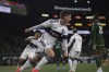 Vancouver Whitecaps midfielder Ryan Gauld scores a goal during the first half of an MLS soccer match against the Portland Timbers Wednesday, Oct. 23, 2024, in Portland, Ore. (AP Photo/Howard Lao)