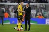 Dortmund's head coach Nuri Sahin, right, talks to teammate Nico Schlotterbeck at the end of the Champions League opening phase soccer match between Real Madrid and Borussia Dortmund at the Santiago Bernabeu stadium in Madrid, Tuesday, Oct. 22, 2024. Real Madrid won 5-2. (AP Photo/Manu Fernandez)