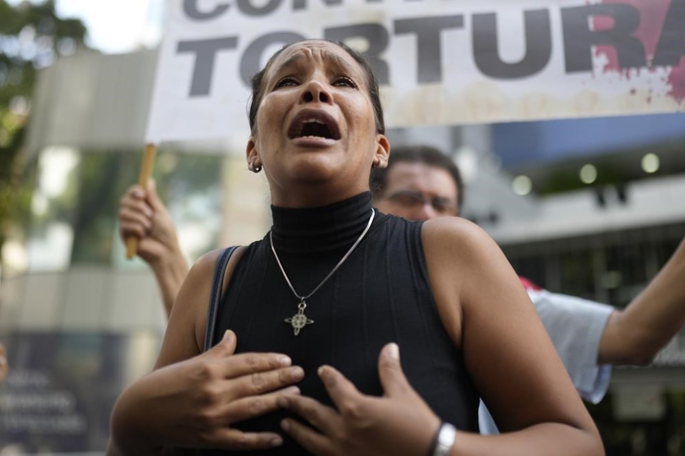 Saudy Gil cries as she protests the conditions at the Tocuyito prison where her son is locked up during a protest outside the Penitentiary Service headquarters in Caracas, Venezuela, Friday, Oct. 18, 2024. Gil said her 23-year-old son was arrested amid a government crackdown after anti-government protests against election results. (AP Photo/Ariana Cubillos)