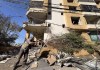 A worker removes the debris of a building that housed the office of pan-Arab TV channel Al-Mayadeen, which is politically allied with Hezbollah, that was hit Wednesday night by an Israeli airstrike, in southern Beirut, Lebanon, Thursday, Oct. 24, 2024. (AP Photo/Hussein Malla)