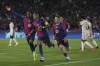 Barcelona's Raphinha, center, celebrates with teammates after scoring the opening goal during the Champions League opening phase soccer match between Barcelona and Bayern Munich at the Lluis Companys Olympic Stadium in Barcelona, Spain, Wednesday, Oct. 23, 2024. (AP Photo/Emilio Morenatti)